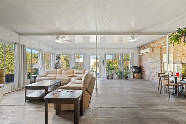 sunroom / solarium with a wall unit AC, plenty of natural light, and ceiling fan