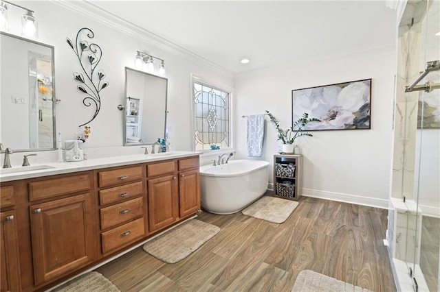 bathroom with wood-type flooring, vanity, shower with separate bathtub, and crown molding