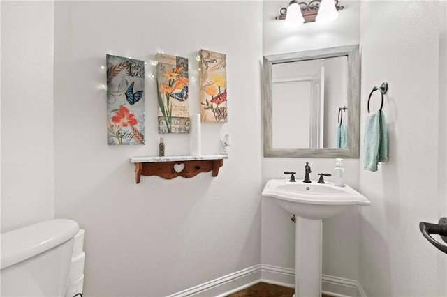 bathroom featuring toilet and sink