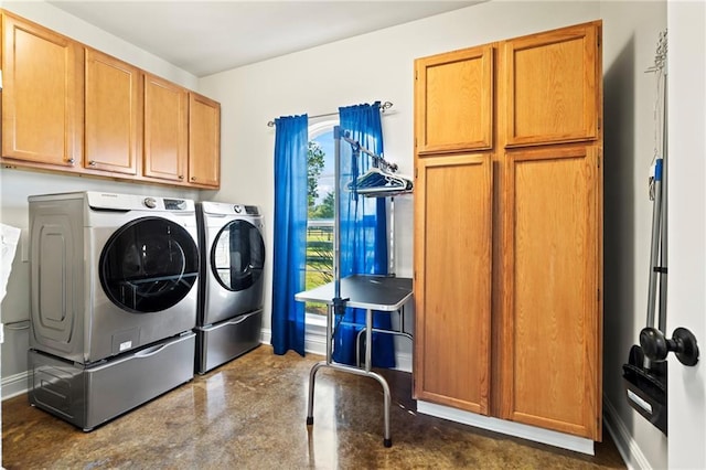 laundry room with cabinets and washing machine and clothes dryer