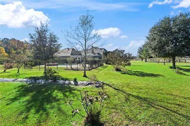 view of home's community featuring a rural view and a lawn