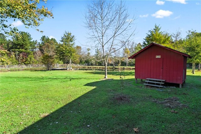 view of yard with a rural view and a storage unit