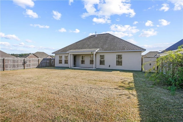 back of property with a yard and a shed