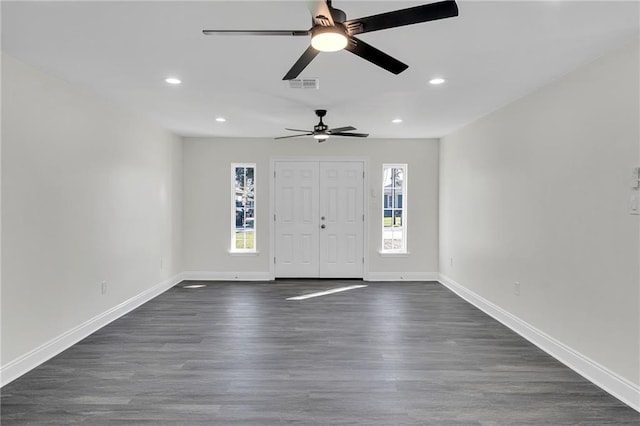 entrance foyer with ceiling fan and dark wood-type flooring