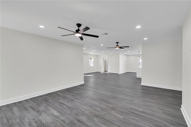 unfurnished living room featuring ceiling fan and dark wood-type flooring