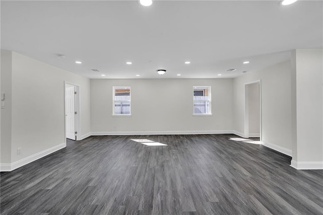 empty room with dark hardwood / wood-style flooring