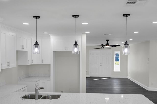 kitchen with white cabinets, sink, dark hardwood / wood-style floors, ceiling fan, and light stone countertops