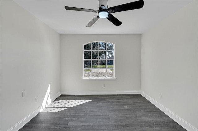 spare room with ceiling fan and dark wood-type flooring