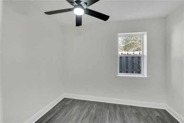 unfurnished room with ceiling fan and dark hardwood / wood-style flooring