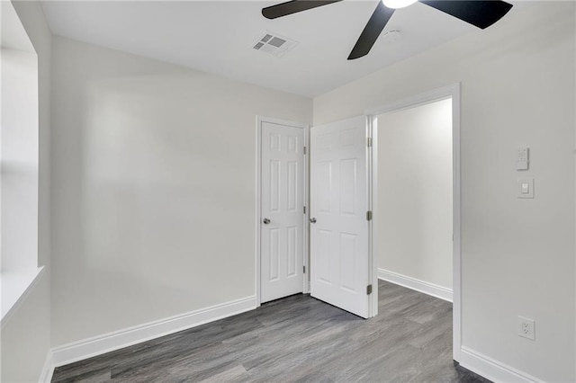 unfurnished bedroom with ceiling fan and wood-type flooring