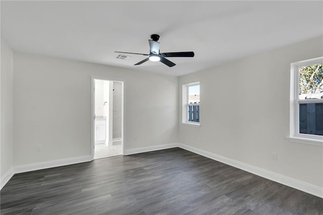 empty room featuring ceiling fan and dark wood-type flooring