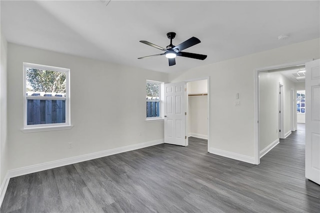 unfurnished bedroom featuring a closet, dark hardwood / wood-style floors, and ceiling fan