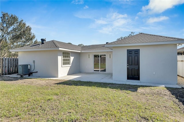 back of property with a patio, central AC unit, and a lawn