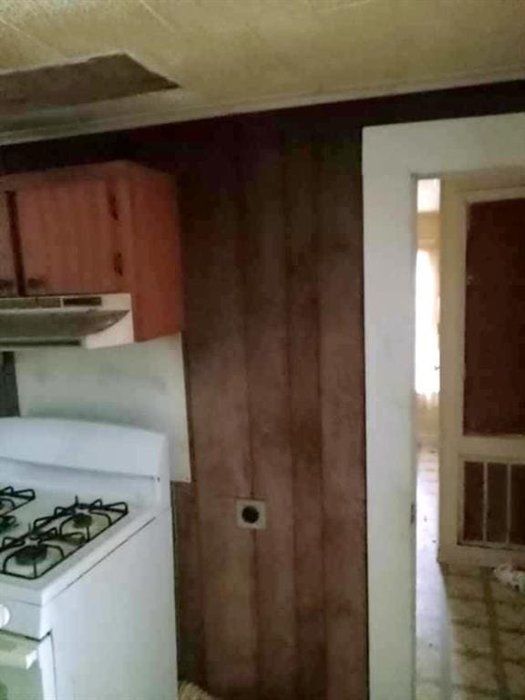 kitchen with white gas range and extractor fan