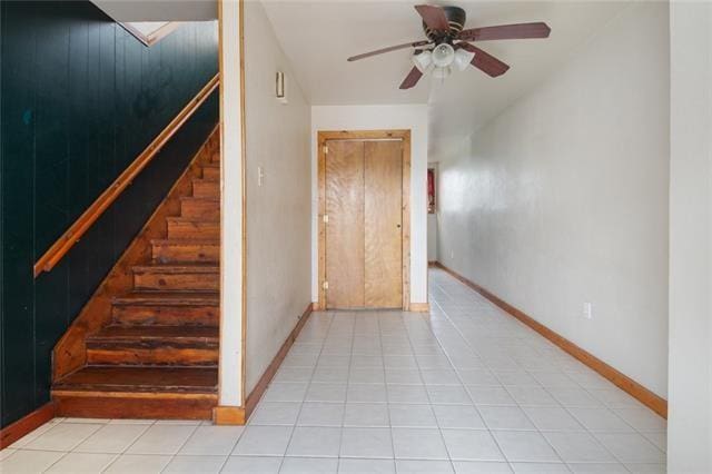 stairs featuring tile patterned floors and ceiling fan