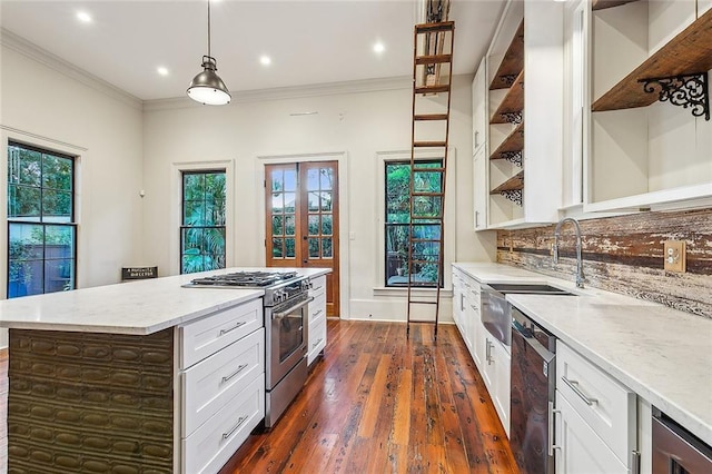 kitchen featuring crown molding, hanging light fixtures, stainless steel range, and black dishwasher