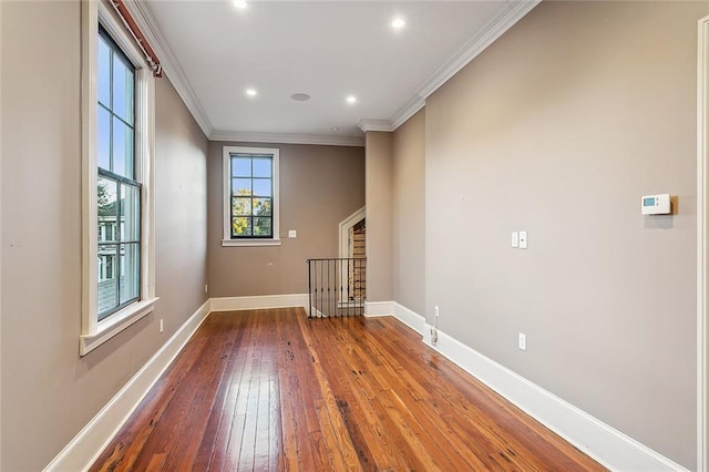 spare room with crown molding and hardwood / wood-style flooring