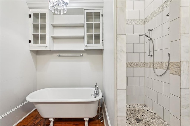 bathroom featuring hardwood / wood-style flooring and shower with separate bathtub