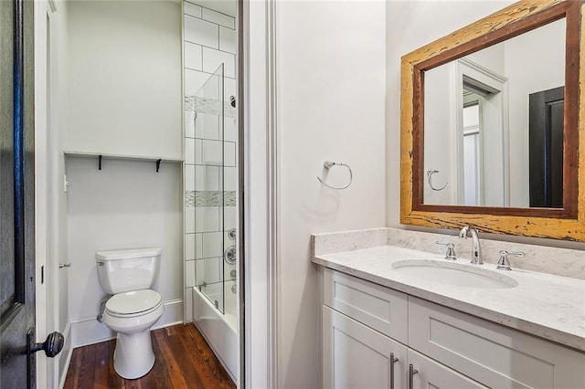 full bathroom featuring bath / shower combo with glass door, wood-type flooring, vanity, and toilet