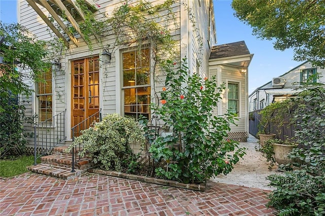 view of exterior entry featuring a patio