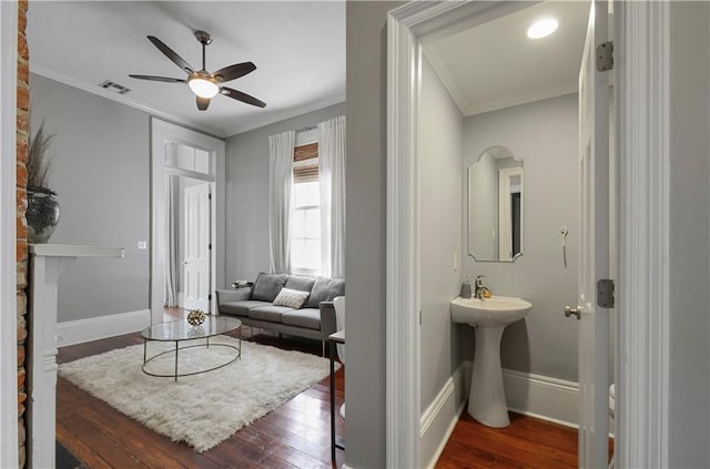 interior space with ceiling fan, hardwood / wood-style floors, sink, and ornamental molding