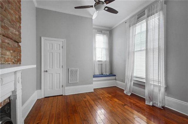 interior space featuring hardwood / wood-style flooring, ceiling fan, ornamental molding, a fireplace, and washer / dryer