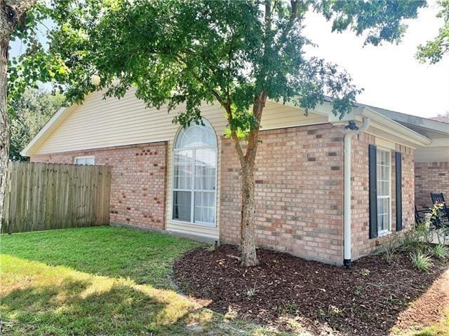 view of property exterior with a lawn