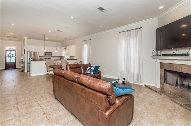 tiled living room with a fireplace and ornamental molding