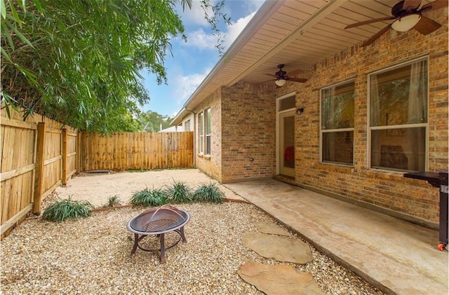 view of patio / terrace with ceiling fan and an outdoor fire pit