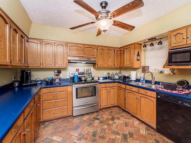 kitchen with ceiling fan, sink, a textured ceiling, and appliances with stainless steel finishes