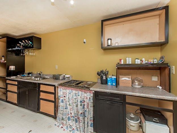 bar featuring sink and stainless steel gas cooktop