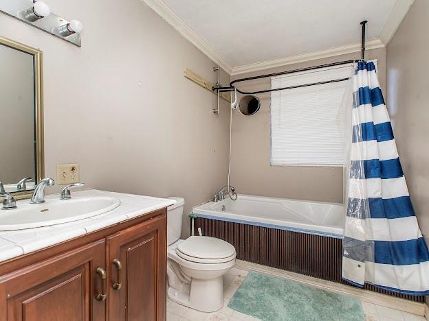 full bathroom featuring toilet, tile patterned flooring, vanity, and ornamental molding