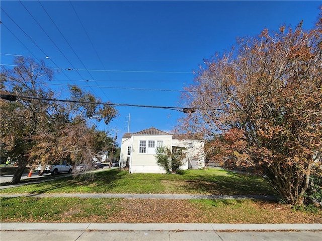 view of side of home with a lawn