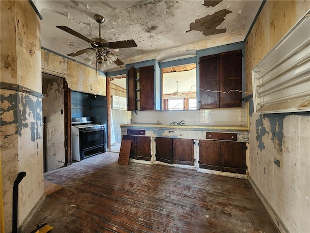 kitchen with range with gas stovetop, dark wood-style flooring, ceiling fan, dark brown cabinetry, and tasteful backsplash