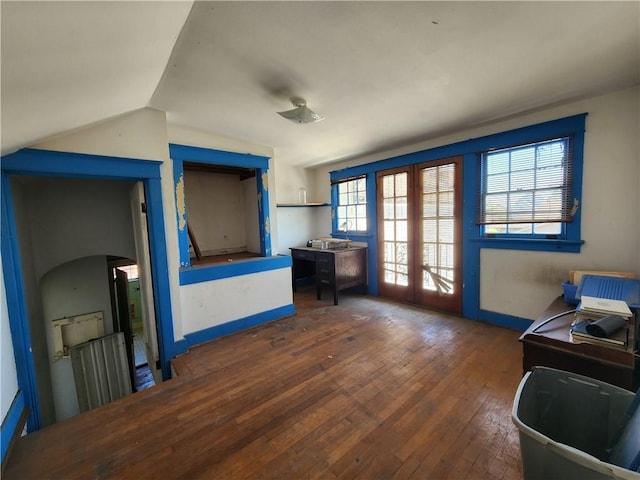 office space featuring hardwood / wood-style flooring, french doors, baseboards, and lofted ceiling