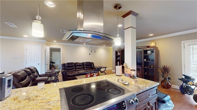 kitchen featuring island range hood, decorative light fixtures, stainless steel range with electric stovetop, crown molding, and light stone countertops