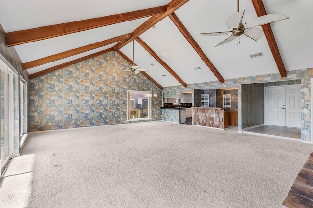 unfurnished living room featuring ceiling fan, beamed ceiling, high vaulted ceiling, and hardwood / wood-style flooring