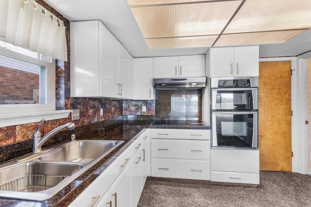 229 Constellation Dr, Slidell, LA 70458 - kitchen with under cabinet range hood, carpet flooring, a sink, double oven, and white cabinets