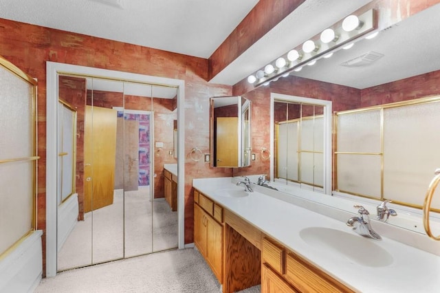 229 Constellation Dr, Slidell, LA 70458 - full bathroom with a sink, double vanity, a shower with shower door, and visible vents