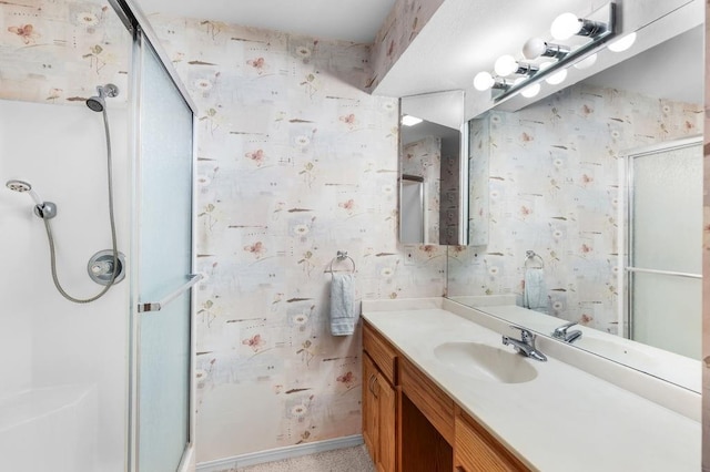 bathroom with vanity and a shower with shower door