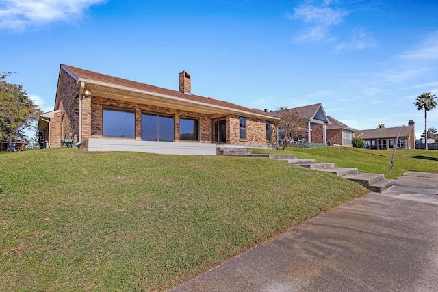 229 Constellation Dr, Slidell, LA 70458 - view of front of property featuring a front lawn, brick siding, and a chimney