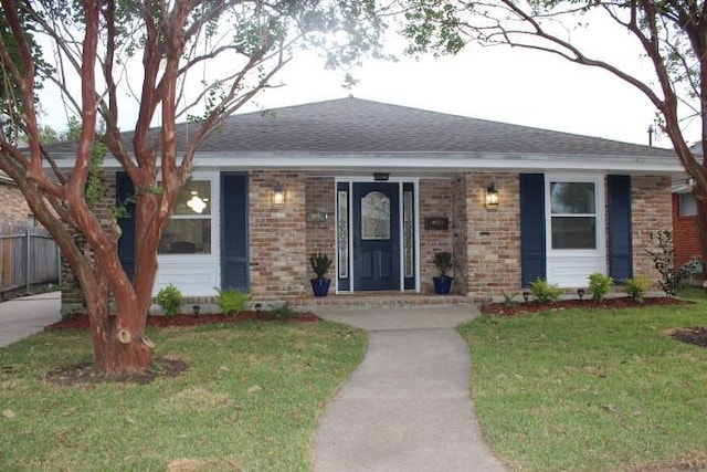 ranch-style house featuring a front lawn