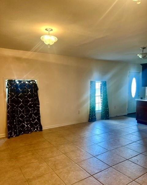 kitchen featuring decorative light fixtures, light tile patterned flooring, sink, and stainless steel appliances