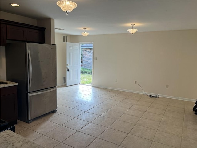 full bathroom featuring tile patterned flooring, vanity, tiled shower / bath combo, and toilet