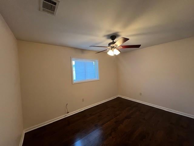 spare room featuring dark hardwood / wood-style floors and ceiling fan