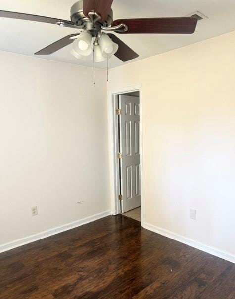 spare room with dark hardwood / wood-style floors and ceiling fan