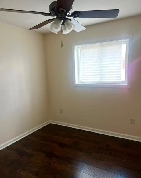 unfurnished room featuring dark hardwood / wood-style flooring and ceiling fan