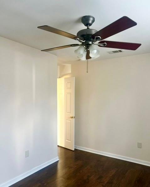 spare room with dark wood-type flooring