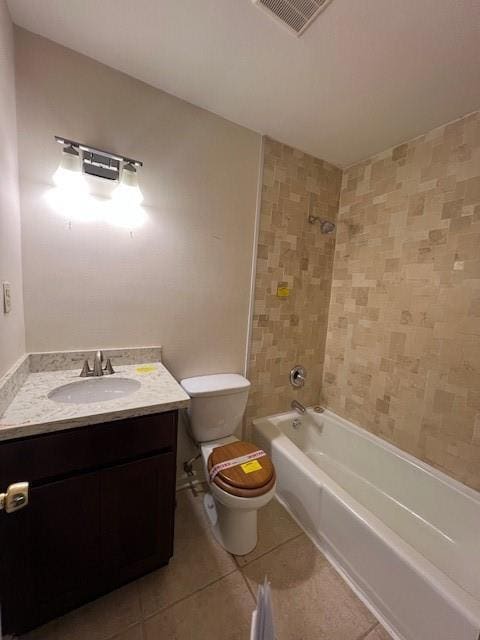 full bathroom with vanity, tile patterned floors, tiled shower / bath combo, and toilet