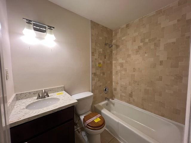 full bathroom featuring vanity, tiled shower / bath combo, and toilet